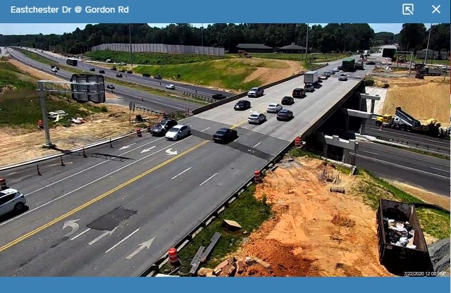 NCDOT traffic camera image showing installation of future overhead ramp guide signs for new ramps
                                                 to I-74 from Eastchester Drive, July 2020