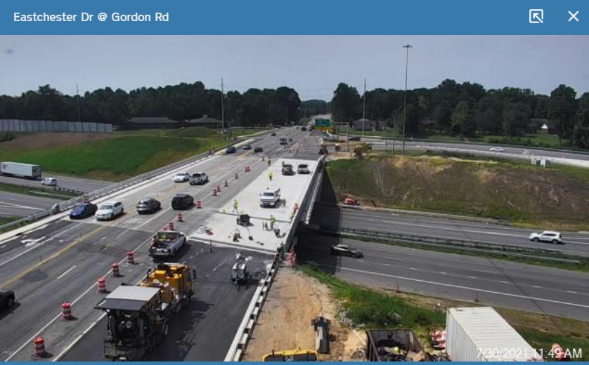 NCDOT traffic camera image showing final paving of new westbound section 
      of future US 70 bridge over I-74 in High Point, July 2021