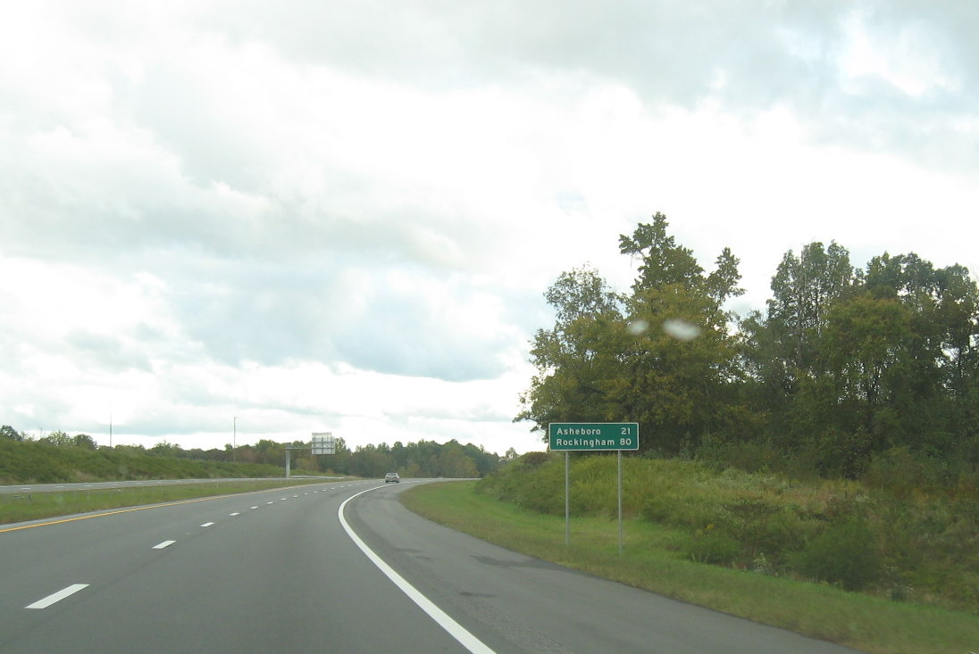Photo of mileage sign on new portion of I-74 East freeway beyond I-85 exit 
south of High Point in October 2011