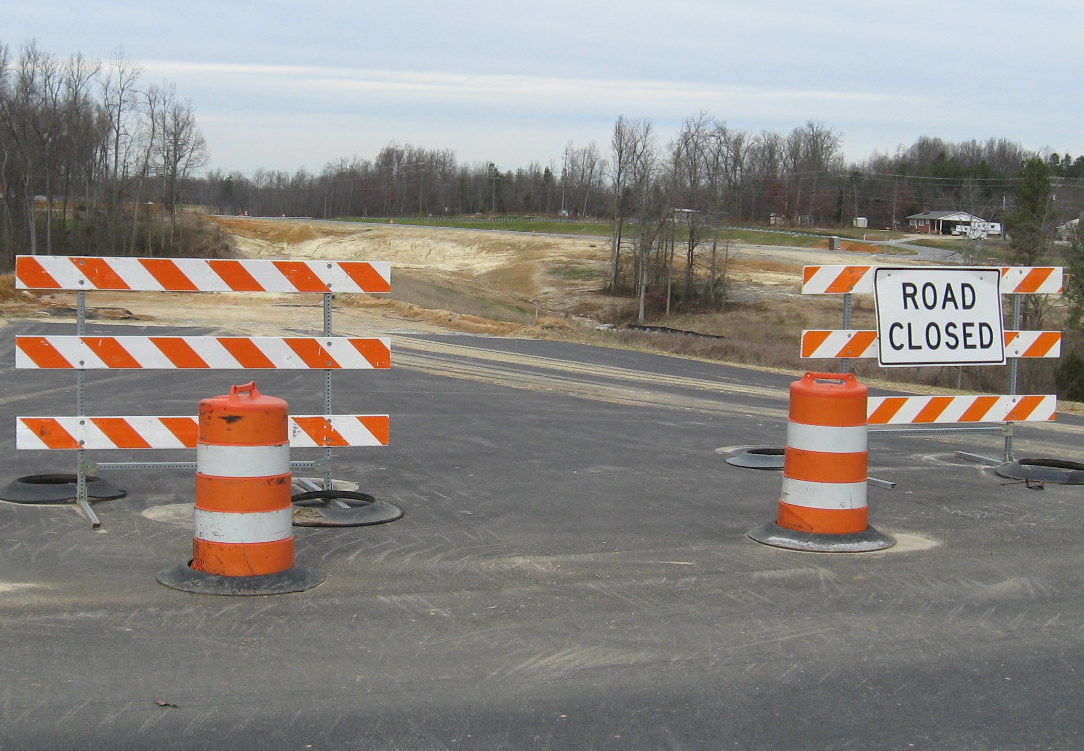 Photo of removing old alignment of Cedar Square Road for I-74 construction 
in Dec. 2009