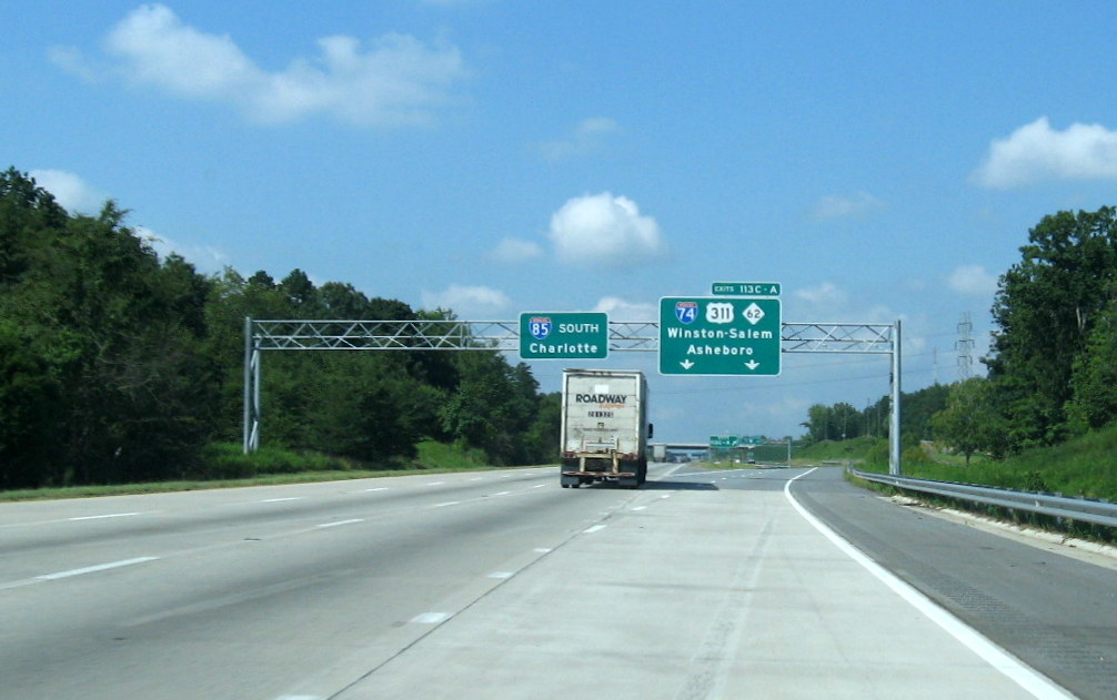 Photo of overhead signage for I-74/US 311 interchange at ramp to C/D lanes on 
I-85 South, Aug. 2012