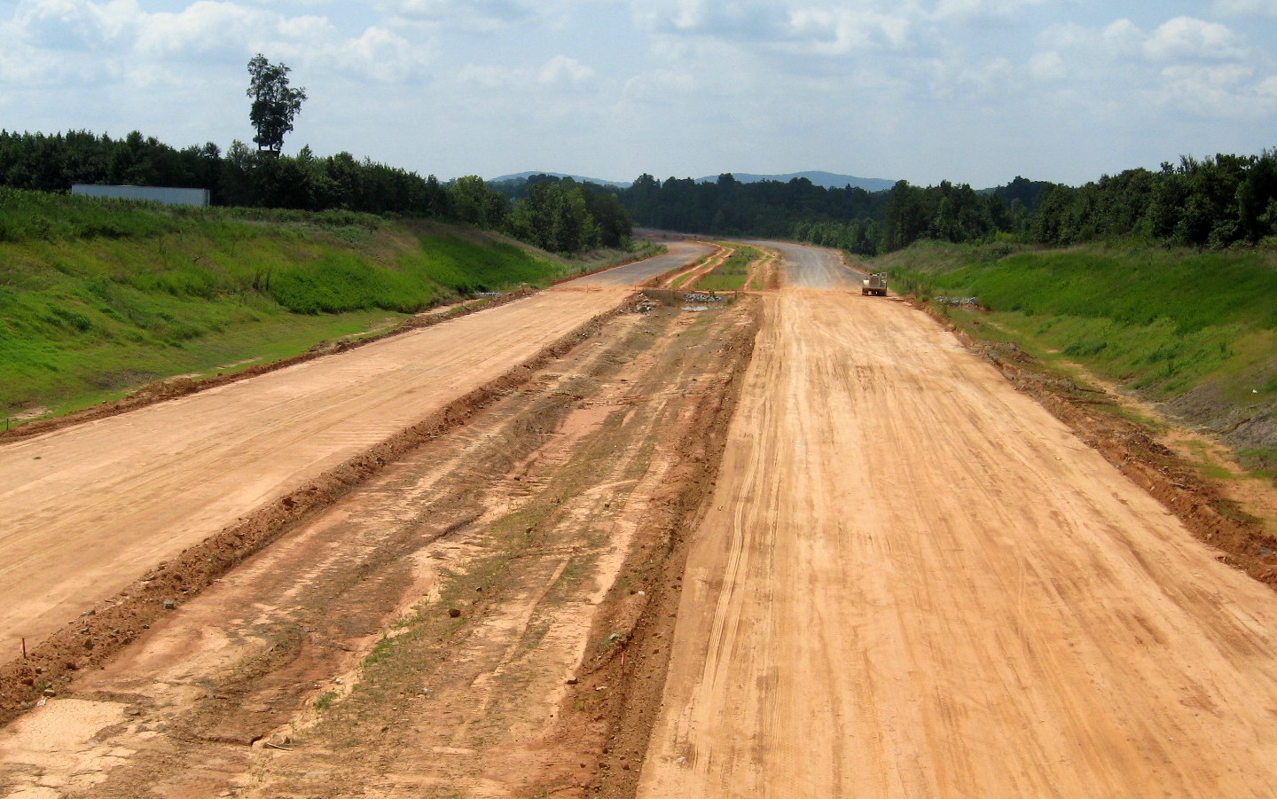 Photo showing view south of railroad bridge along graded alignment of future 
I-74 freeway in Sophia, Aug. 2012