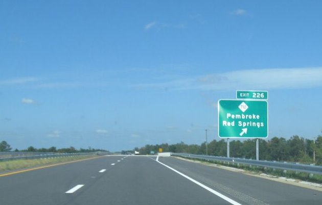 Photo of exit signage for NC 710 on I-74/US 74 freeway showing old (wrong) 
exit number in Oct. 2008