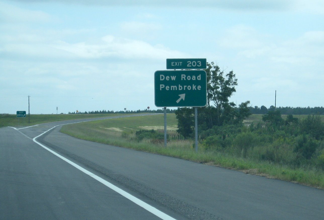 Photo of Dew Road exit sign showing revised exit number changed from contract 
documents in 2007