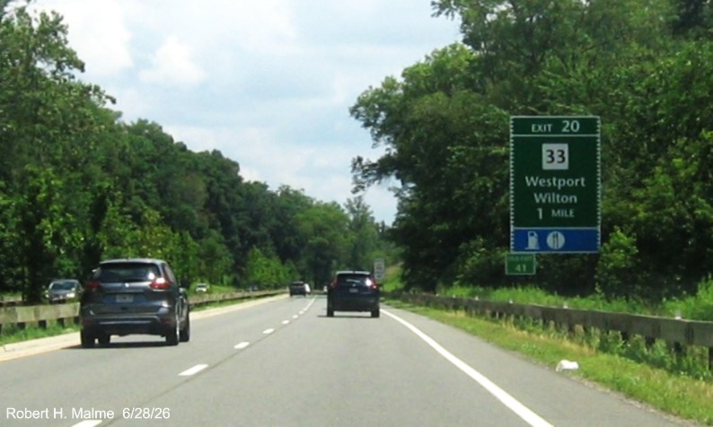 Image of the 1 Mile advance sign for the CT 33 exit, with new milepost based exit number 
 on CT 15 North/Merritt Parkway in Westport and Old Exit 41 tab below on support, June 2026