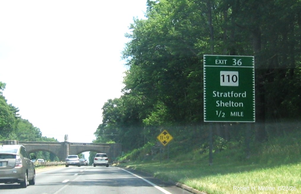 Image of 1/2 mile advance sign for the CT 110 exit, with new milepost based exit 
 number on CT 15 North/Merritt Parkway in Stratford, June 2026