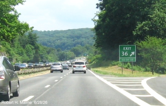 Image of gore sign for the CT 110 exit, with new milepost based exit number and Old Exit 53
 sign on support post on CT 15 North/Merritt Parkway in Stratford, June 2026