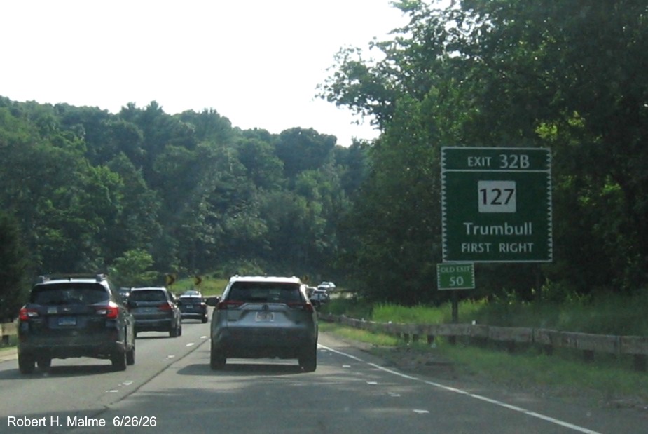 Image of ground mounted 1/2 Mile advance sign for the CT 127 exit, with new milepost 
 based exit number and Old Exit 50 sign on support post on CT 15 South/Merritt Parkway in Trumbull, June 2026