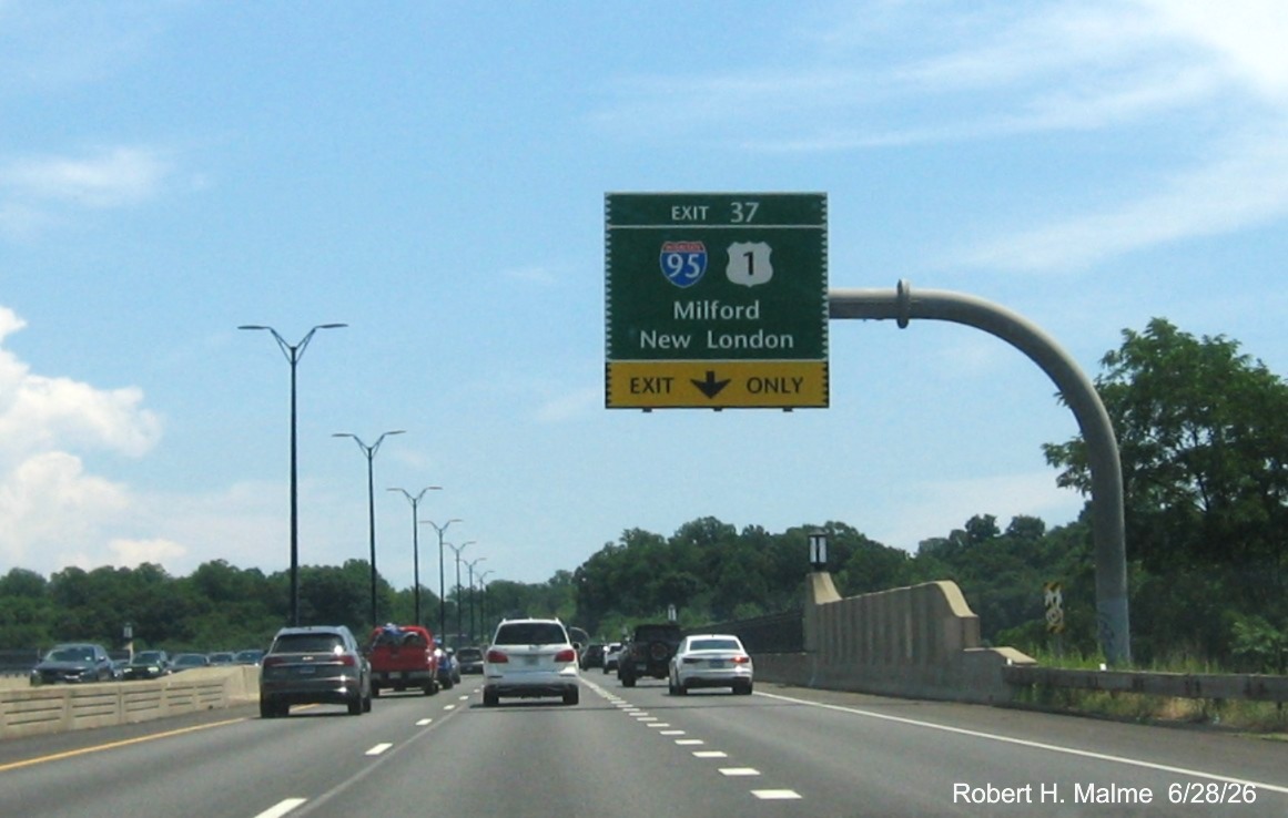 Image of 1/2 mile advance overhead sign for the (To) I-95/US 1 exit, with new milepost 
 based exit number and Old Exit 54 sign on support post on CT 15 North/Merritt Parkway in Stratford, June 2026
