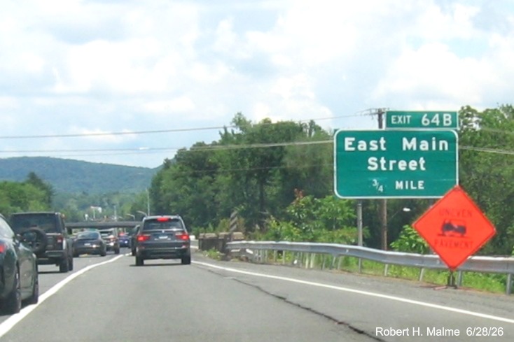 Image of ground mounted 3/4 Mile advance sign for the East Main Street exit, with
 new milepost based exit number overlay on exit tab on CT 15 North/Cross Parkway in Meriden, June 2026