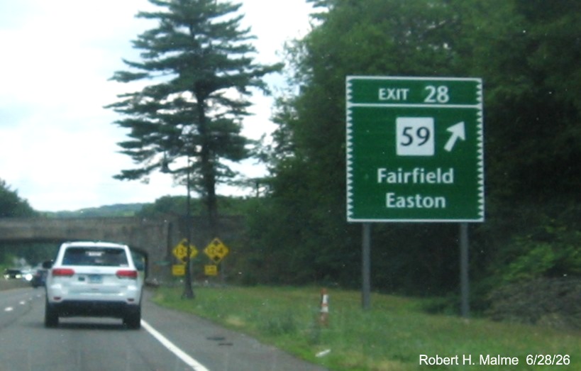 Image of ground mounted ramp sign for the CT 59 exit, with new milepost based exit 
 number on CT 15 North/Merritt Parkway in Fairfield, June 2026