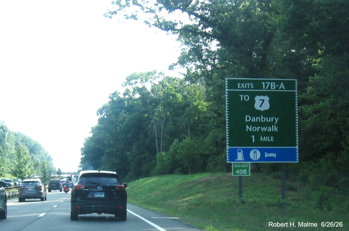 Image of 1 Mile advance sign for the To US 7 North exit, now with new milepost based exit 
 numbers and small Old Exit 40B sign on support post on CT 15 South/Merritt Parkway in Norwalk