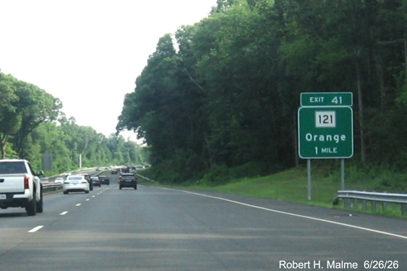 Image of 1 mile advance ground mounted sign for the CT 121 exit, with new milepost based exit 
 number on CT 15 South/Cross Parkway in Orange, June 2026