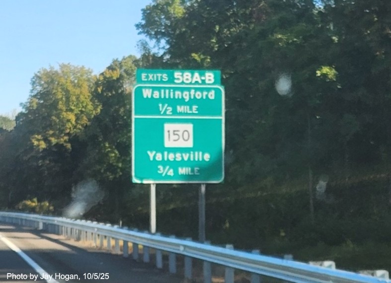 Image of ground mounted advance sign for the Wallingford and CT 150 exits, with
 new milepost based exit number overlays on exit tab on CT 15 North/Cross Parkway in Wallingford, by Jay Hogan, August 2025