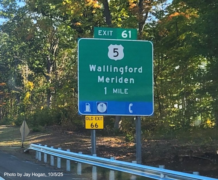 Image of ground mounted 1 Mile advance sign for the US 5 exit, with
 new milepost based exit number overlay on exit tab and yellow Old Exit 66 sign on support post on CT 15 North/Cross Parkway 
 in Wallingford, by Jay Hogan, August 2025