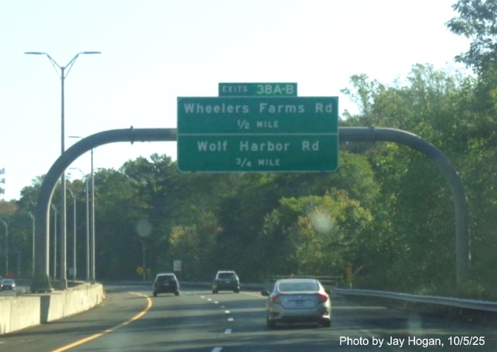 Image of overhead advance signs for the Wheelers Farm Road and Wolf Harbor Road exits, 
 with new milepost based exit numbers on CT 15 North/Cross Parkway in Milford, by Jay Hogan, October 2025