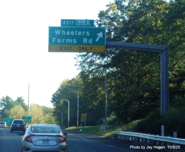 Image of overhead ramp sign for the Wheelers Farm Road exit, with new milepost based 
 exit number on CT 15 North/Cross Parkway in Milford, by Jay Hogan, October 2025