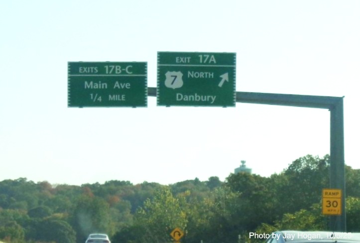 Image of overhead signs at US 7 North exit ramp, with new milepost based exit
 numbers on CT 15 North/Merritt Parkway in Norwalk