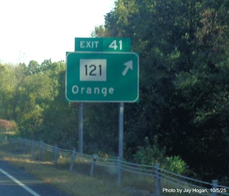 Image of ground mounted ramp sign for the CT 121 exit, with new milepost based exit 
 number on CT 15 North/Cross Parkway in Orange, by Jay Hogan, October 2025