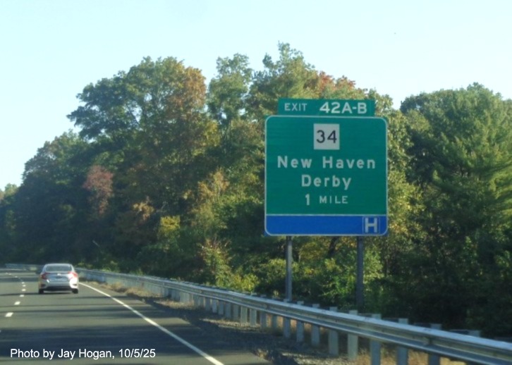 Image of ground mounted 1 Mile advance sign for the CT 34 exits, with new milepost 
 based exit numbers on CT 15 North/Cross Parkway in Derby, by Jay Hogan, October 2025