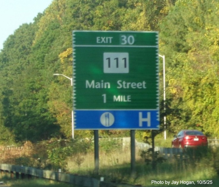Image of 1 Mile advance sign for the CT 111/Main Street exit, with new milepost based exit 
 number on CT 15 South/Merritt Parkway in Bridgeport, by Jay Hogan, October 2025