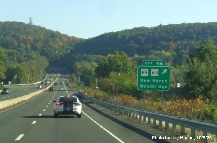 Image of ground mounted ramp sign for the CT 69/63 exit, with new milepost 
 based exit numbers on CT 15 North/Cross Parkway in Woodridge, by Jay Hogan, October 2025