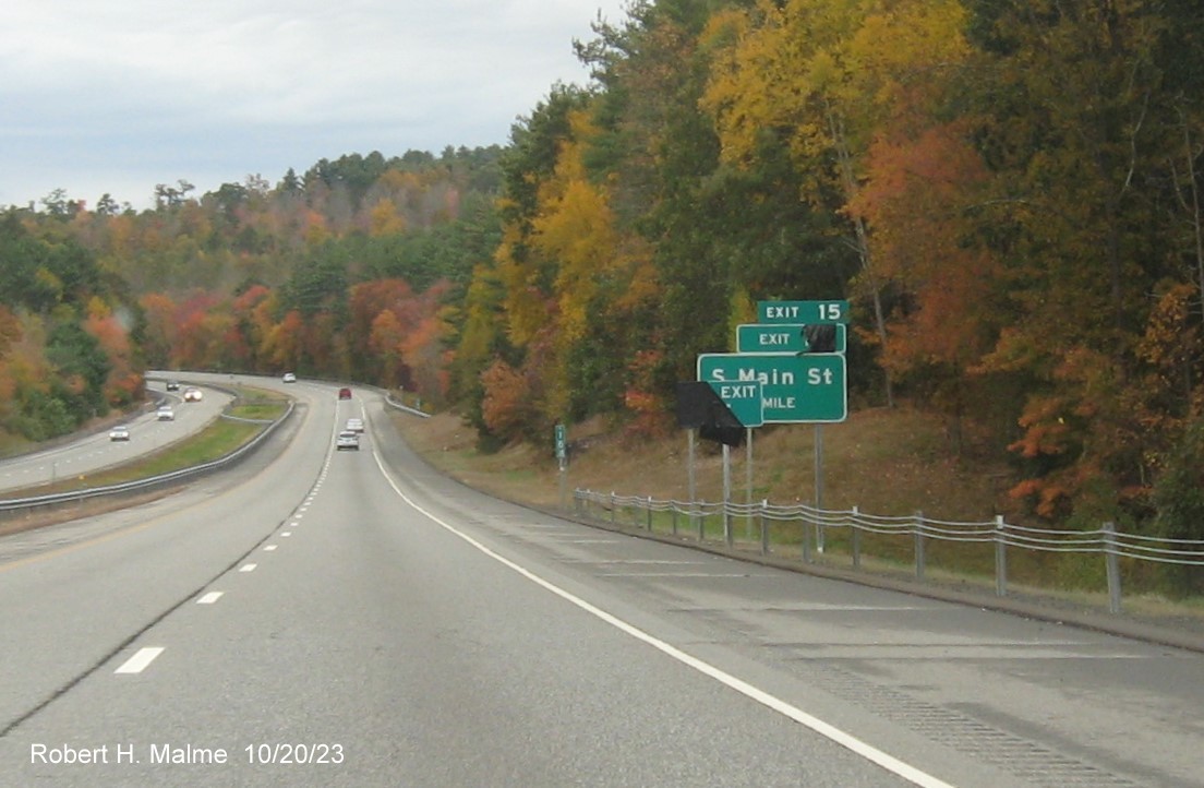 Image of recently placed 1 mile advance sign for South Main Street exit on CT 2 West with covered over
      future milepost exit number ( ) and Old Exit 15 sign, October 2023