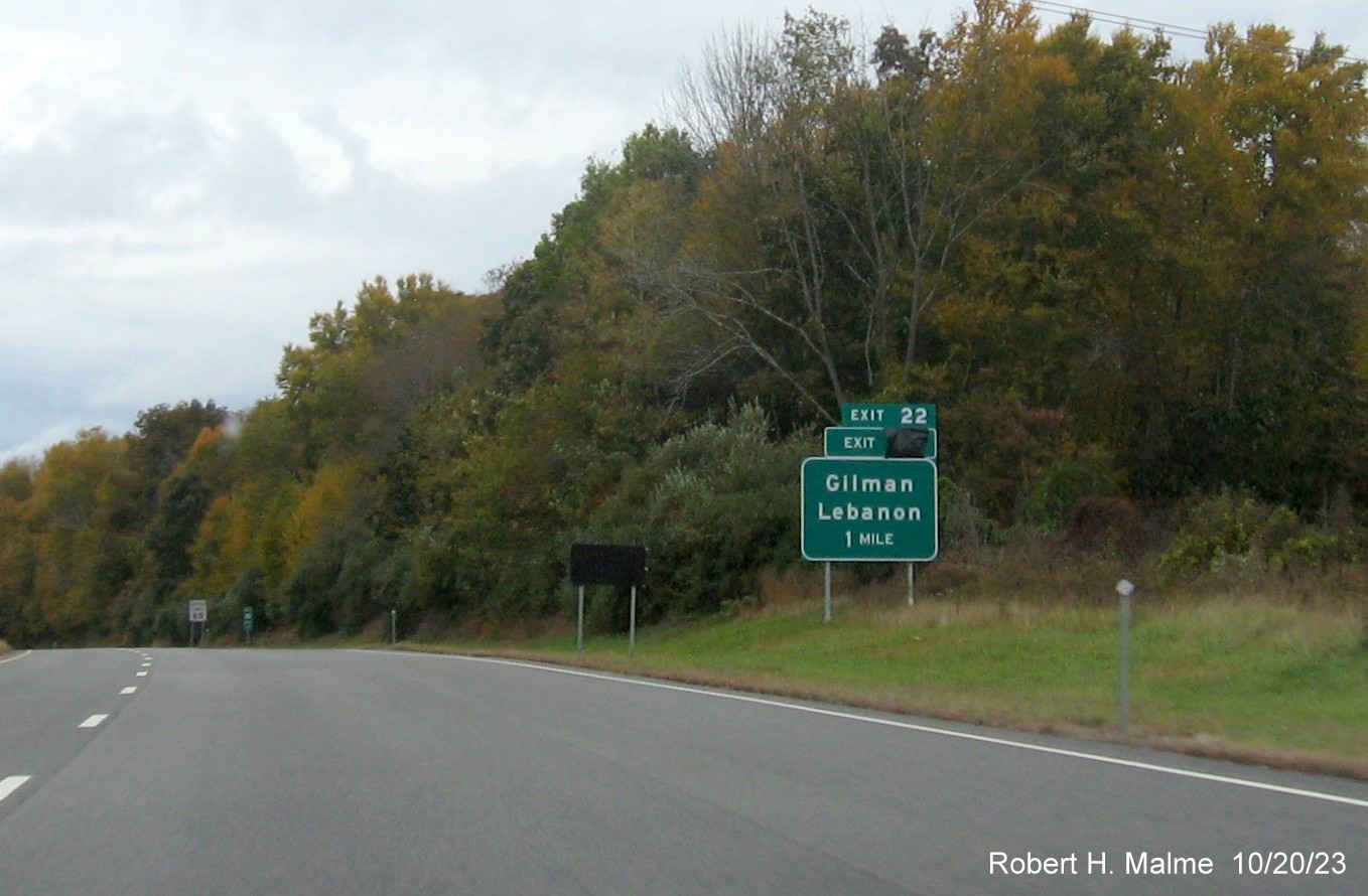 Image of new 1 mile advance sign for Gilman/Lebanon exit on CT 2 West with covered 
      over future exit number (30) and Old Exit 22 sign, October 2023