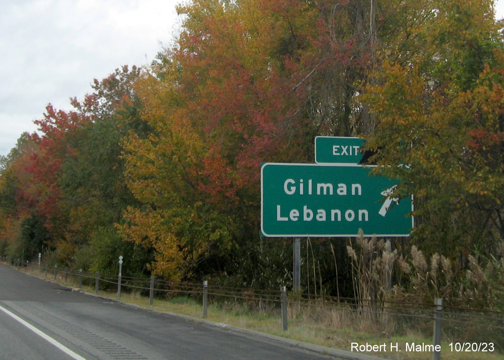 Image of new ground mounted ramp sign for Gilman/Lebanon exit on CT 2 West with covered 
      over future exit number (33) and also Old Exit 23 sign, October 2023