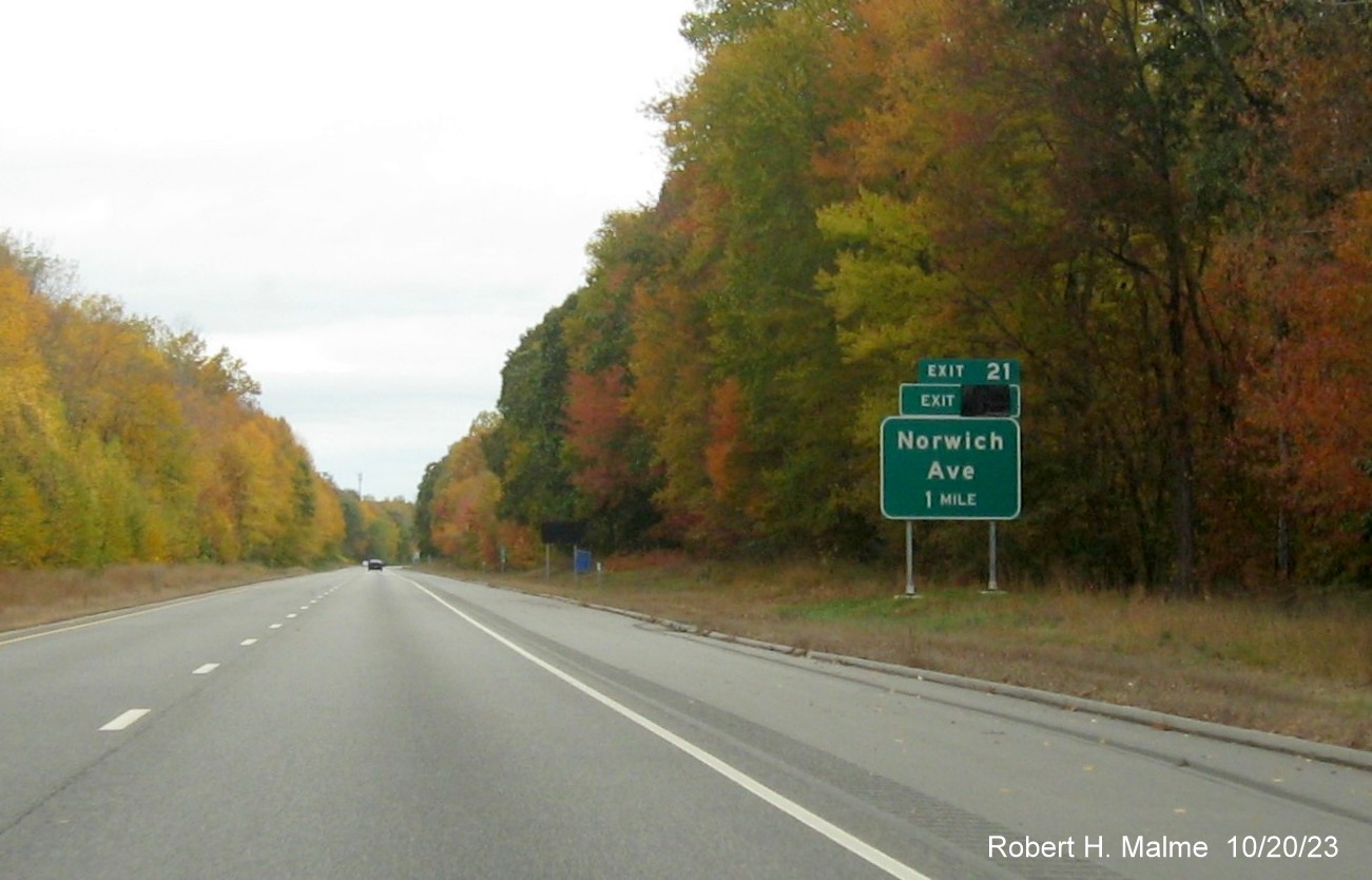 Image of new 1 mile advance sign for Norwich Avenue exit on CT 2 West in Colchester with covered 
      over future exit number (26) but no Old Exit 21 sign, October 2023