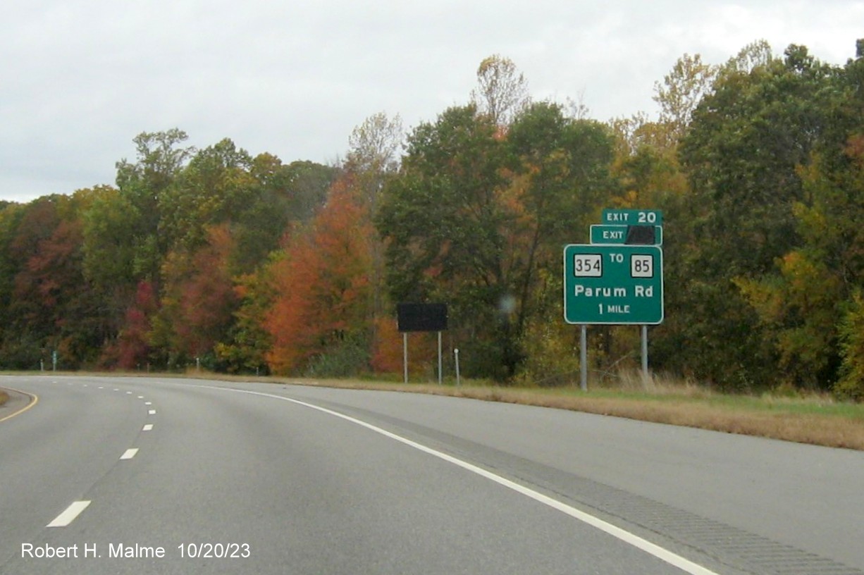 Image of new 1 mile advance sign for CT 354/Parum Road exit on CT 2 West in Colchester with covered
over future exit number (25) and also Old Exit 20 sign, October 2023