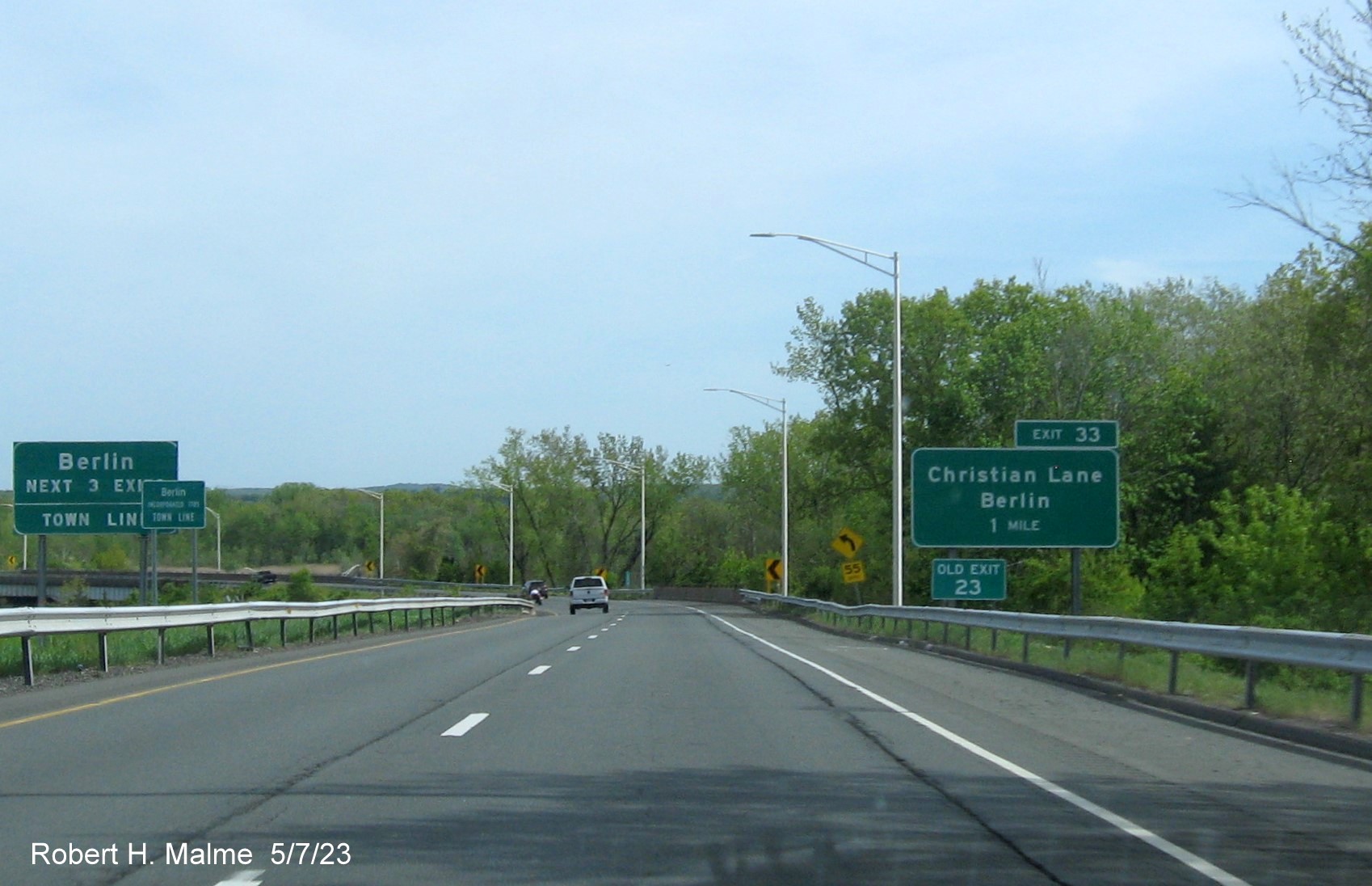 Image of ground mounted 1 Mile advance sign for Christian Lane exit with new milepost based exit number and Old Exit 23 
      sign attached below on CT 9 South in Berlin, May 2023
