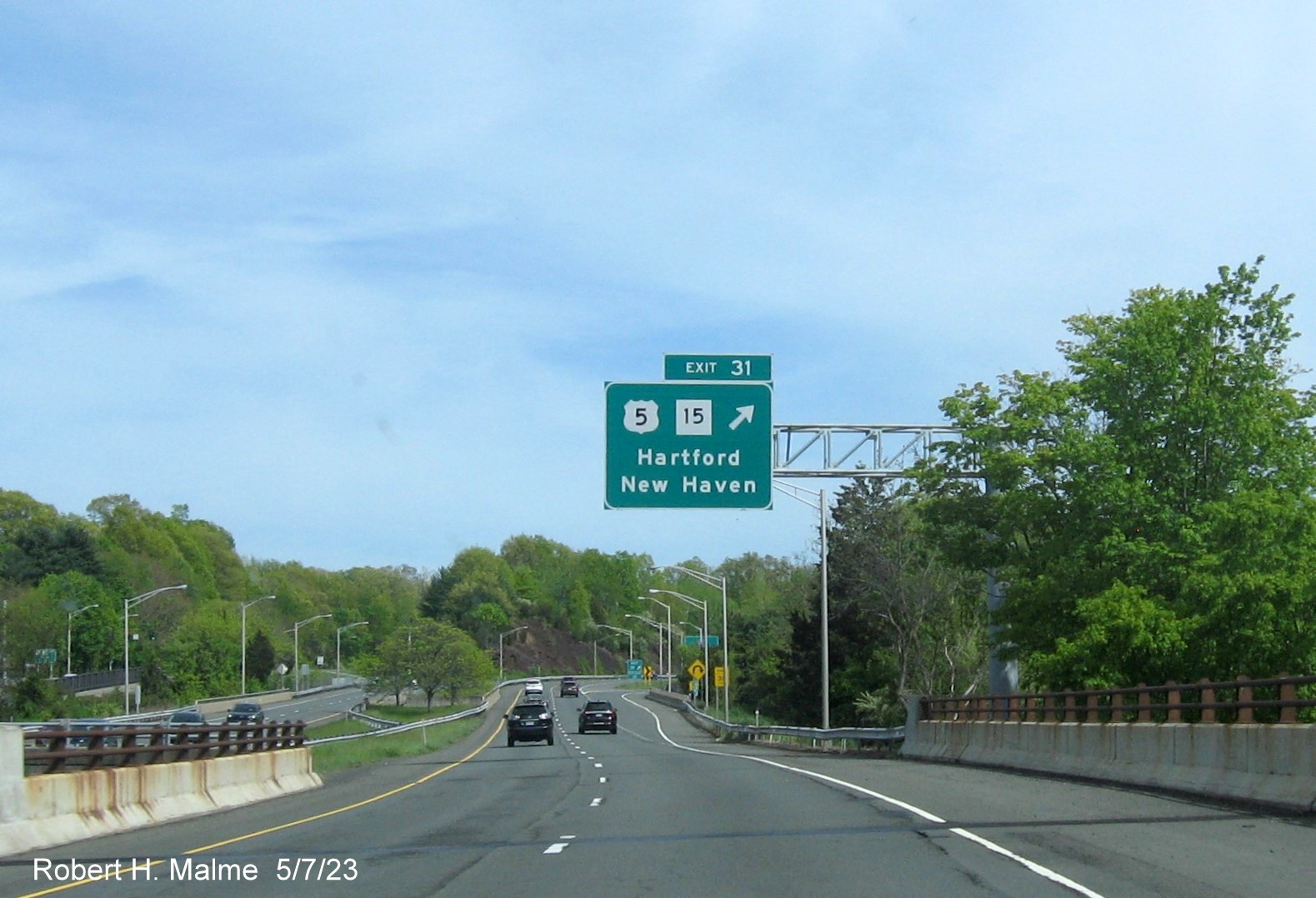Image of overhead ramp sign US 5/CT 15 exit with new milepost based 
        exit number on CT 9 South in Berlin, May 2023