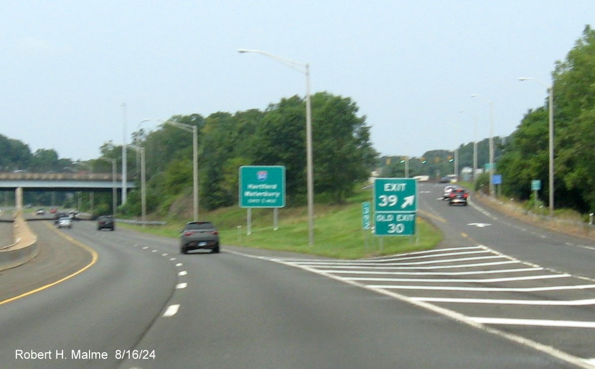 Image of gore sign for CT 71 exit with new milepost based exit number and 
      separate Old Exit sign attached on CT 9 North in Newington, August 2024