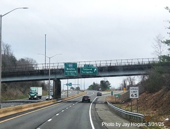 Image of ramp sign for Tolland Turnpike exit with new milepost based exit number 
	on I-291 East in Manchester, photo by Jay Hogan, March 2025