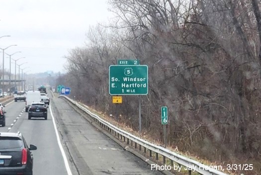 Image of 1 mile advance sign for US 5 exit with new milepost based exit number 
	and yellow old exit sign below on I-291 East in Windsor, photo by Jay Hogan, March 2025