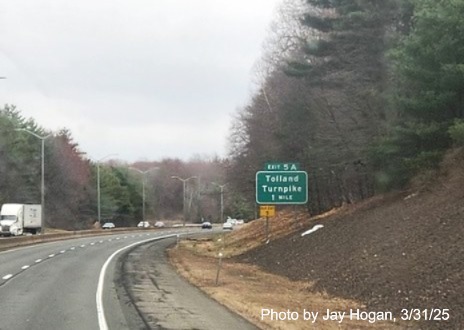 Image of 1 mile advance sign for Tolland Turnpike exit with new milepost based exit number 
	and yellow old exit sign below on I-291 East in Windsor, photo by Jay Hogan, March 2025