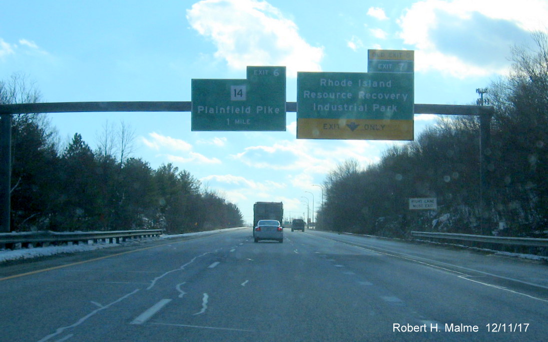 Image of overhead exit signs for RI Industrial Park and RI 14 on I-295 South in Cranston with new exit numbers