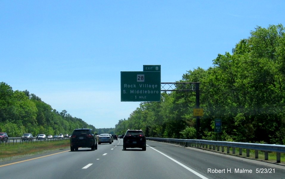 Image of 1 mile advance overhead sign for MA 28 exit with new milepost based exit number and yellow Old Exit 3 
                                       advisory sign on support on I-495 South in Middleboro, May 2021