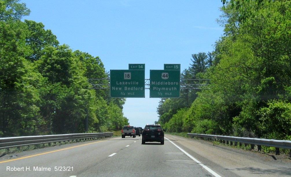 Image of overhead advance signs for MA 18 and US 44 exits with new milepost based exit numbers on I-495 South in Middleboro, May 2021