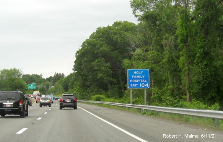 Image of blue auxiliary sign for MA 110 exit with new milepost based exit number on I-495 North in 
                                          Lawrence, June 2021