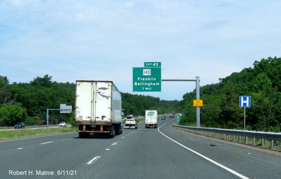 Image of 1 Mile advance overhead sign for MA 140 Franklin exit with new milepost based exit number and yellow Old Exit 17 advisory sign on support on I-495 North in Franklin, June 2021