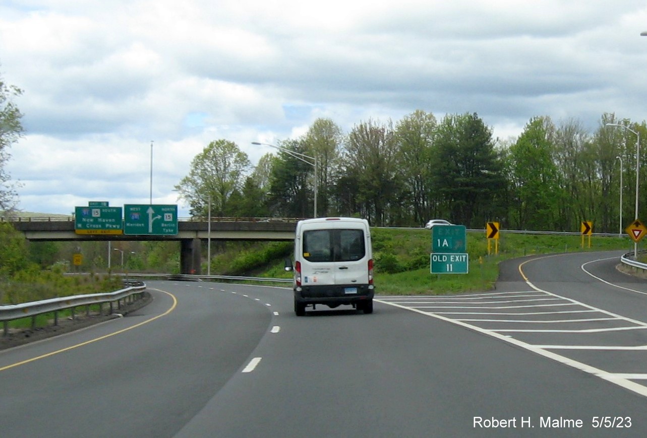 Image of gore sign for I-91 North exit with new milepost based exit number and Old Exit 10 sign below at beginning of I-691 in Meriden CT, May 2023