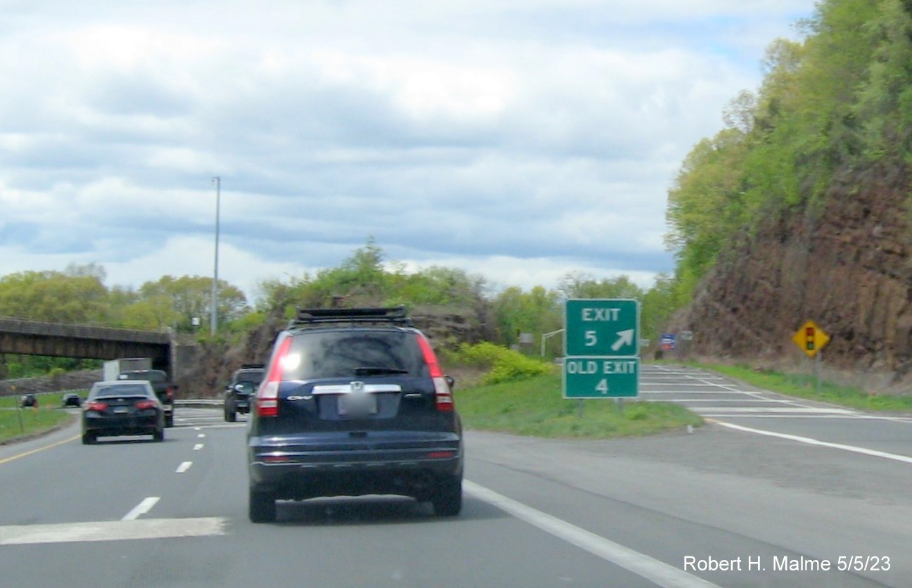 Image of gore sign for CT 322 exit with new milepost based exit number and Old Exit 4 sign below on I-691 
                                      West in Southington, May 2023