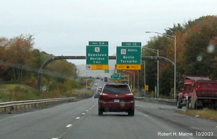 Image of new overhead signs for the US 5 and CT 15 South exits with new milepost based exit numbers 
         on I-691 West in Meriden, October 2023