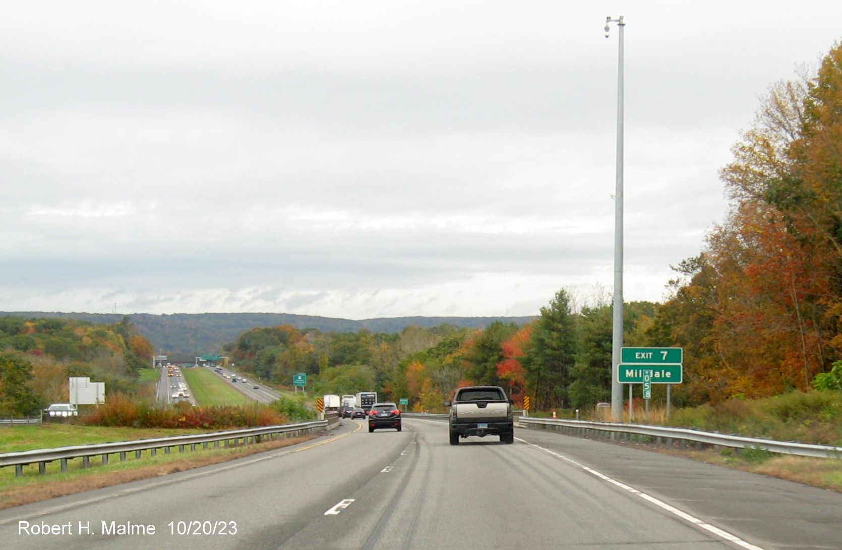 Image of new auxiliary sign for the CT 10 exit with new mile marker with 3 digit number in front
         on I-691 West in Cheshire, October 2023