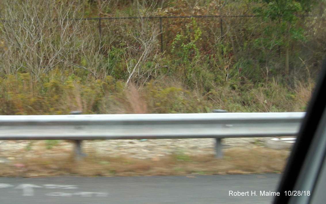 Image of cement foundation for future 1 mile advance sign support post along I-90/Mass Pike East in Weston