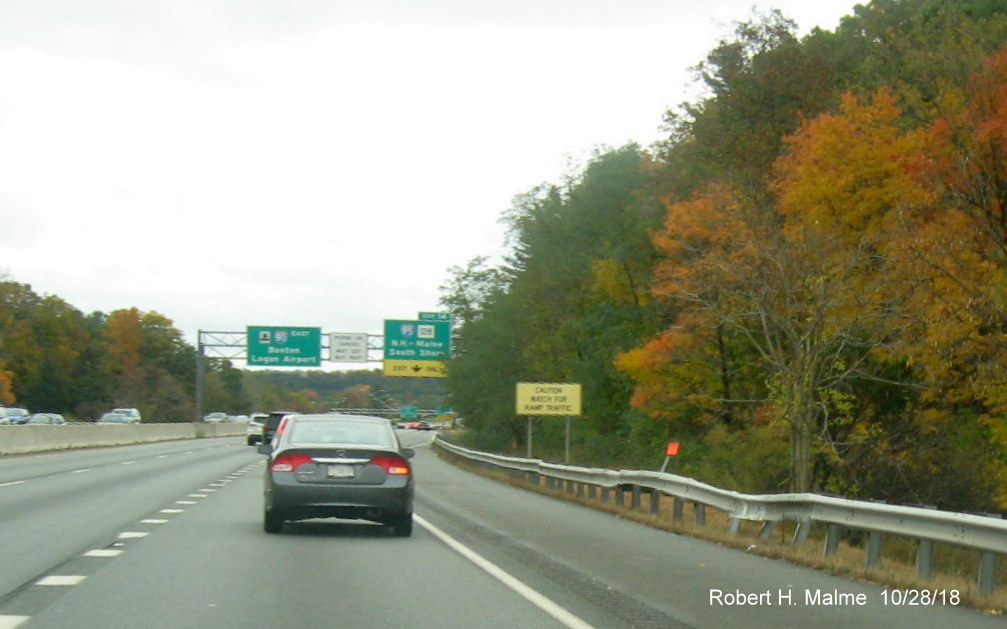 Image of orange contractor tag marking future site of support post for 1/2 mile advance sign for I-95 exit on I-90/Mass Pike East in Weston