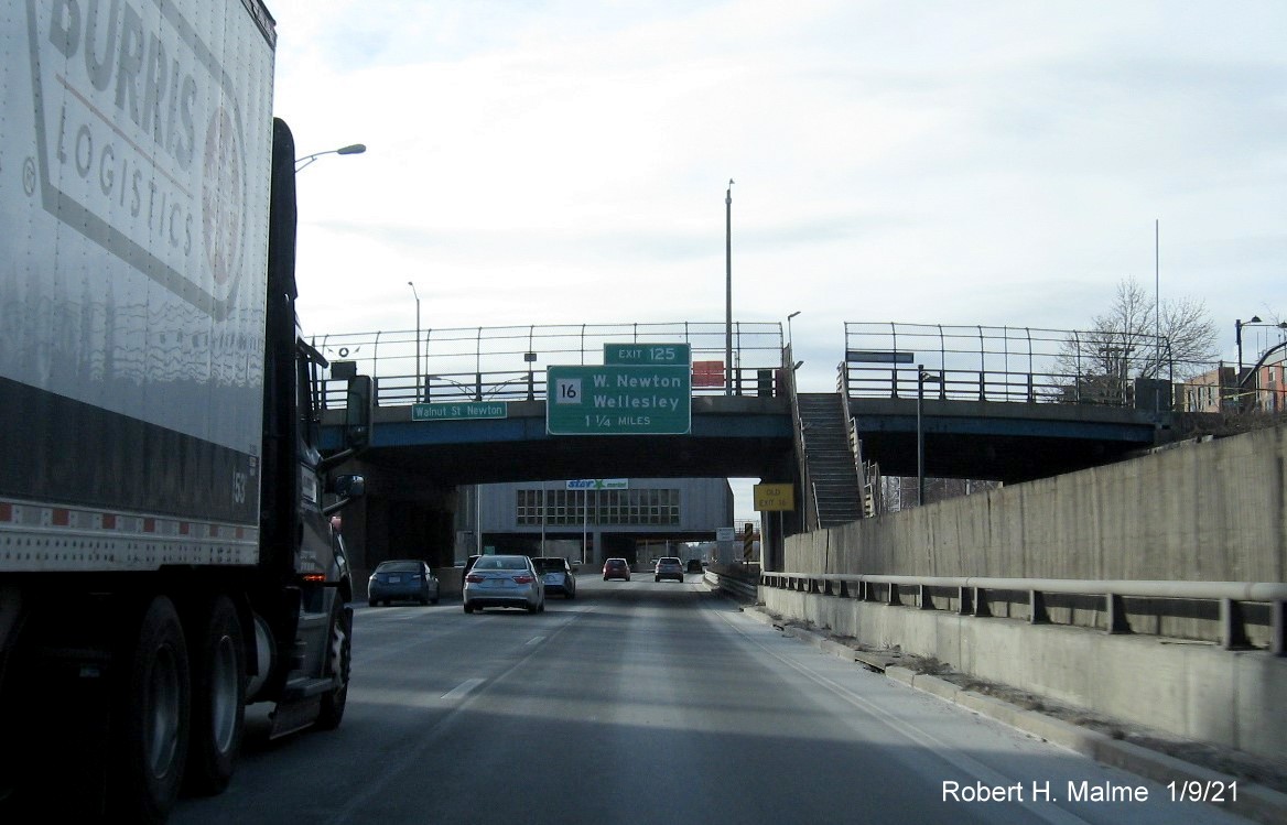 Image of 1 1/4 Miles advance bridge mounted sign for MA 16 Exit with new milepost based number and yellow old Exit 16 sign below on separate posts on I-90 West in Newton, January 2021