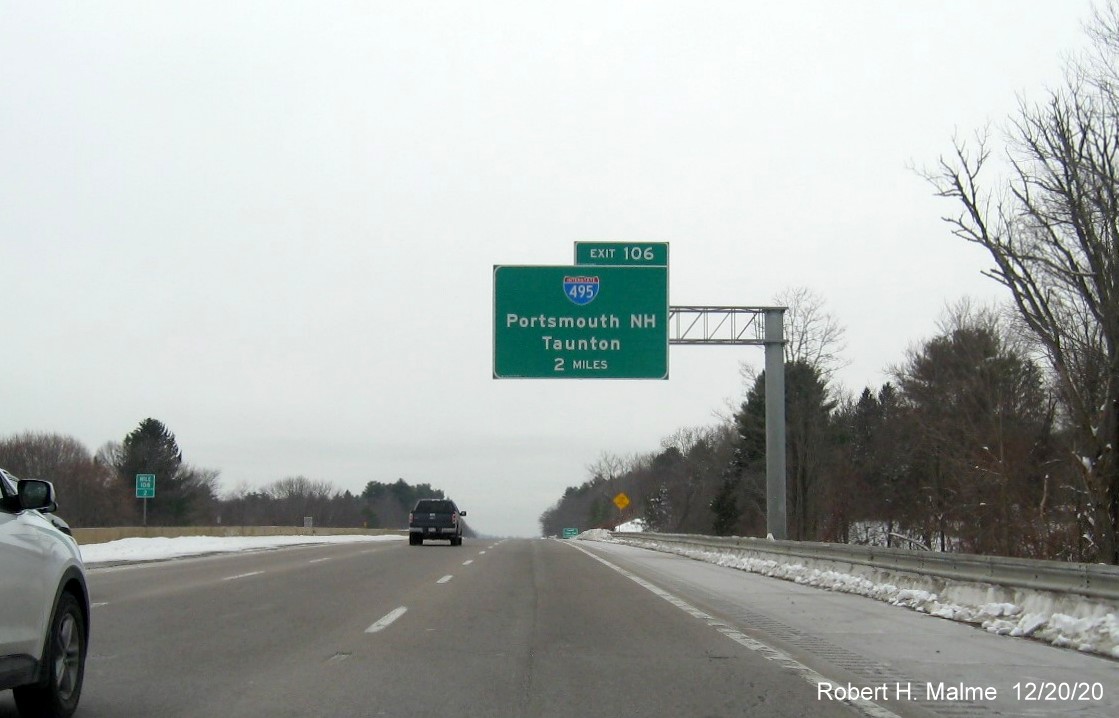 Image of 2-miles advance overhead sign for I-495 exit with new milepost based exit number on I-90/Mass Pike West in Southboro, December 2020